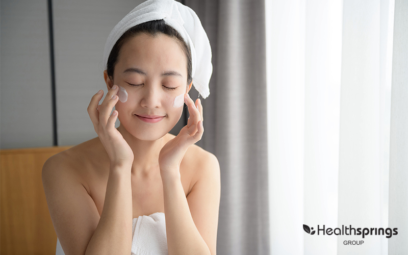 A Person Applying Moisturiser On The Face
