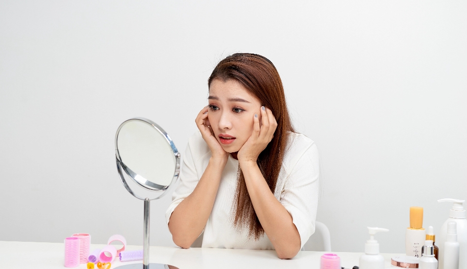 young woman checking her skin